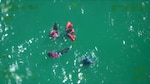 Four survivors of a capsized vessel float in the water approximately 30 miles north of Key West, Florida, Dec. 31, 2025. The boaters tied their life jackets to each other to remain together in the 2 to 4-foot seas. (U.S. Coast Guard photo)