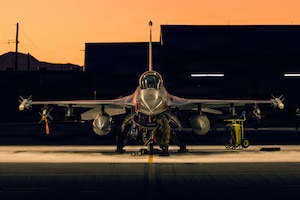 U.S. Air Force Airman 1st Class Noah Chastine, 311th Aircraft Maintenance Unit crew chief, performs scheduled maintenance on an F-16 Fighting Falcon at Holloman Air Force Base, New Mexico, Dec. 11, 2025.