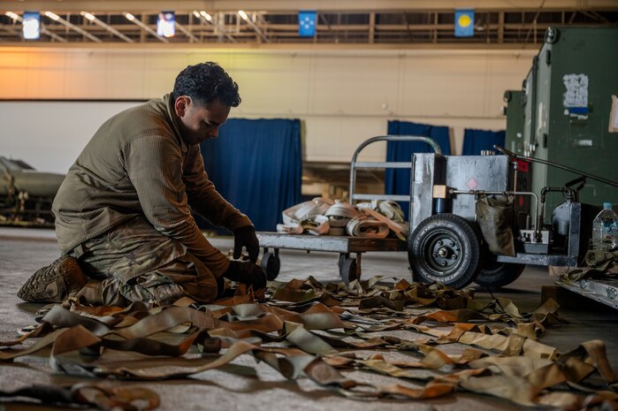 U.S. Air Force Airman 1st Class Roberto Vargas, 13th Fighter Generation Squadron aerospace ground equipment journeyman, prepares cargo straps in support of Cope North 25 at Misawa Air Base, Japan, Jan. 24, 2025