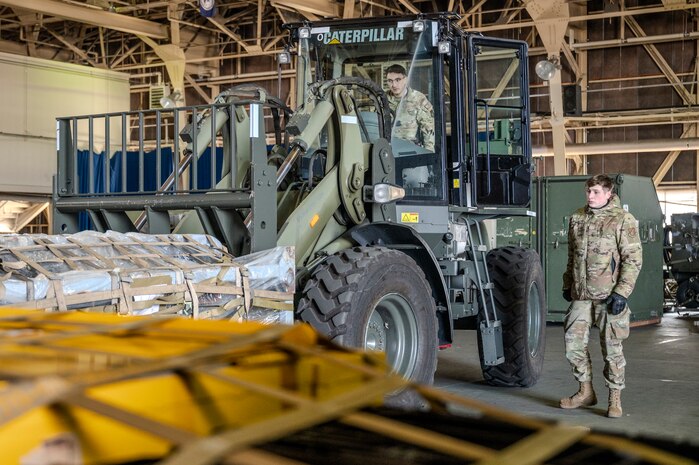 U.S. Air Force Senior Airman Sean Masuhara, left, and Senior Airman Rhett Hammon, 35th Logistic Readiness Squadron outbound cargo technicians, operate heavy machinery to load and prepare cargo in support of Cope North 25 at Misawa Air Base, Japan, Jan. 24, 2025