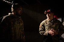 U.S. Air Force Tech. Sgt. Donald Holmes, 35th Security Forces Squadron combat arms training and maintenance (CATM) section chief, speaks with Airman 1st Class Patrick Boyle, 35th Fighter Wing Public Affairs public affairs journeyman, at Misawa Air Base, Japan, Jan. 29, 2025