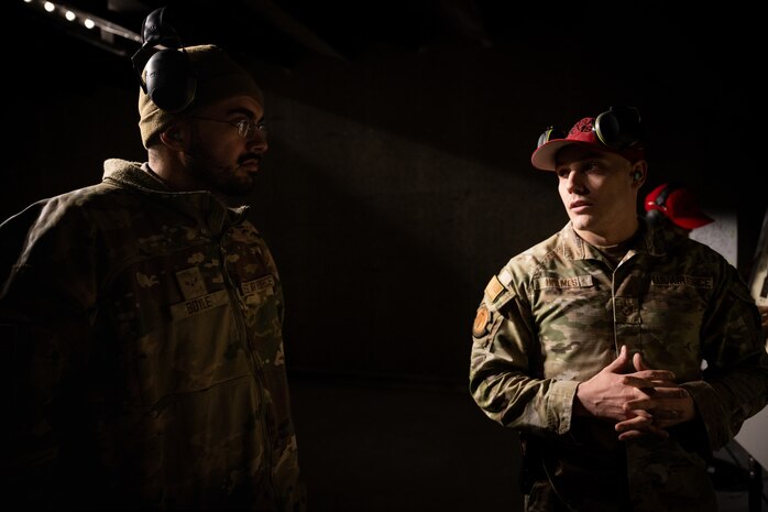 U.S. Air Force Tech. Sgt. Donald Holmes, 35th Security Forces Squadron combat arms training and maintenance (CATM) section chief, speaks with Airman 1st Class Patrick Boyle, 35th Fighter Wing Public Affairs public affairs journeyman, at Misawa Air Base, Japan, Jan. 29, 2025
