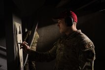 U.S. Air Force Tech. Sgt. Donald Holmes, 35th Security Forces Squadron combat arms training and maintenance (CATM) section chief, marks shots on a target at Misawa Air Base, Jan. 29, 2025