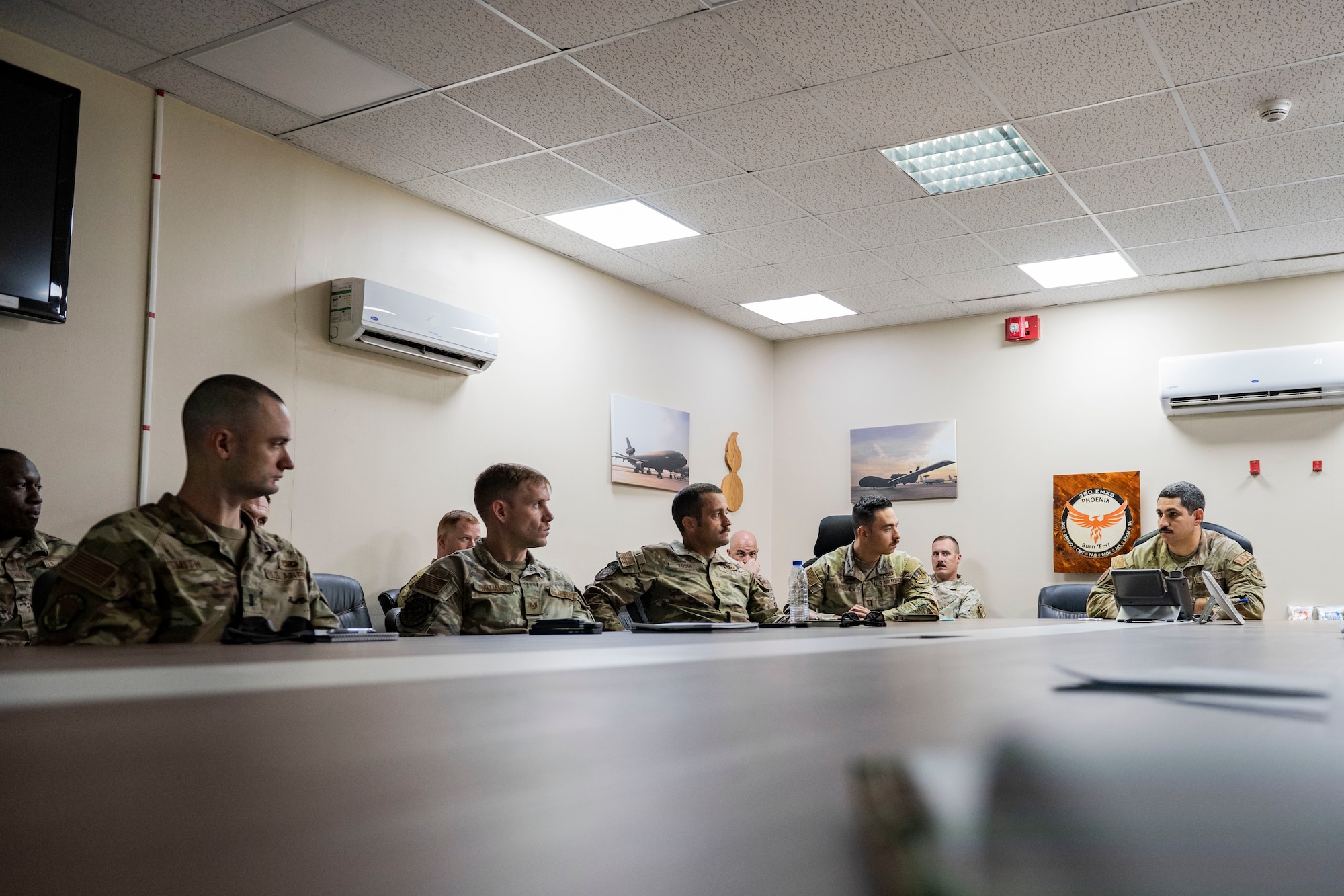 Airmen and soldier refuel helicopter.