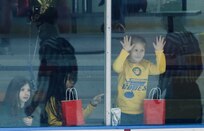 The family of Illinois Army National Guard Staff Sgt. Paul Smith watches the action during the North American Hockey League game between the Springfield (IL) Junior Blues and the Janesville (WI) Jets in Springfield, Illinois, on Jan. 31.