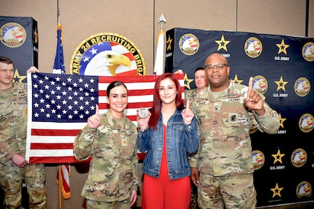 U.S. Army Col. Sherdrick Rankin, Commander, 2nd Recruiting Brigade and Maj. Lauren Hall, pose with new Army recruit, Sophie Marie Stewart at the conclusion of her Oath of Enlistment Ceremony on Jan. 29, 2025 at Redstone Arsenal, AL. Stewart enlisted as a 68T Animal Care Specialist in taking the first steps towards fulfilling her dream of a career in the medical field.