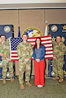 U.S. Army recruit Sophie Marie Stewart poses with recruiters Staff Sgt. Chance Schutter (center), Sgt. 1st Class Chuck Vandell (left), and 1st Sgt. Troy Woody (right) at the conclusion of her Oath of Enlistment Ceremony, Jan. 29, 2025 at U.S. Army 2nd Recruiting Brigade headquarters in Redstone Arsenal, AL. Stewart enlisted as a 68T Animal Care Specialist, in taking the first steps towards fulfilling her dream of a career in the medical field.