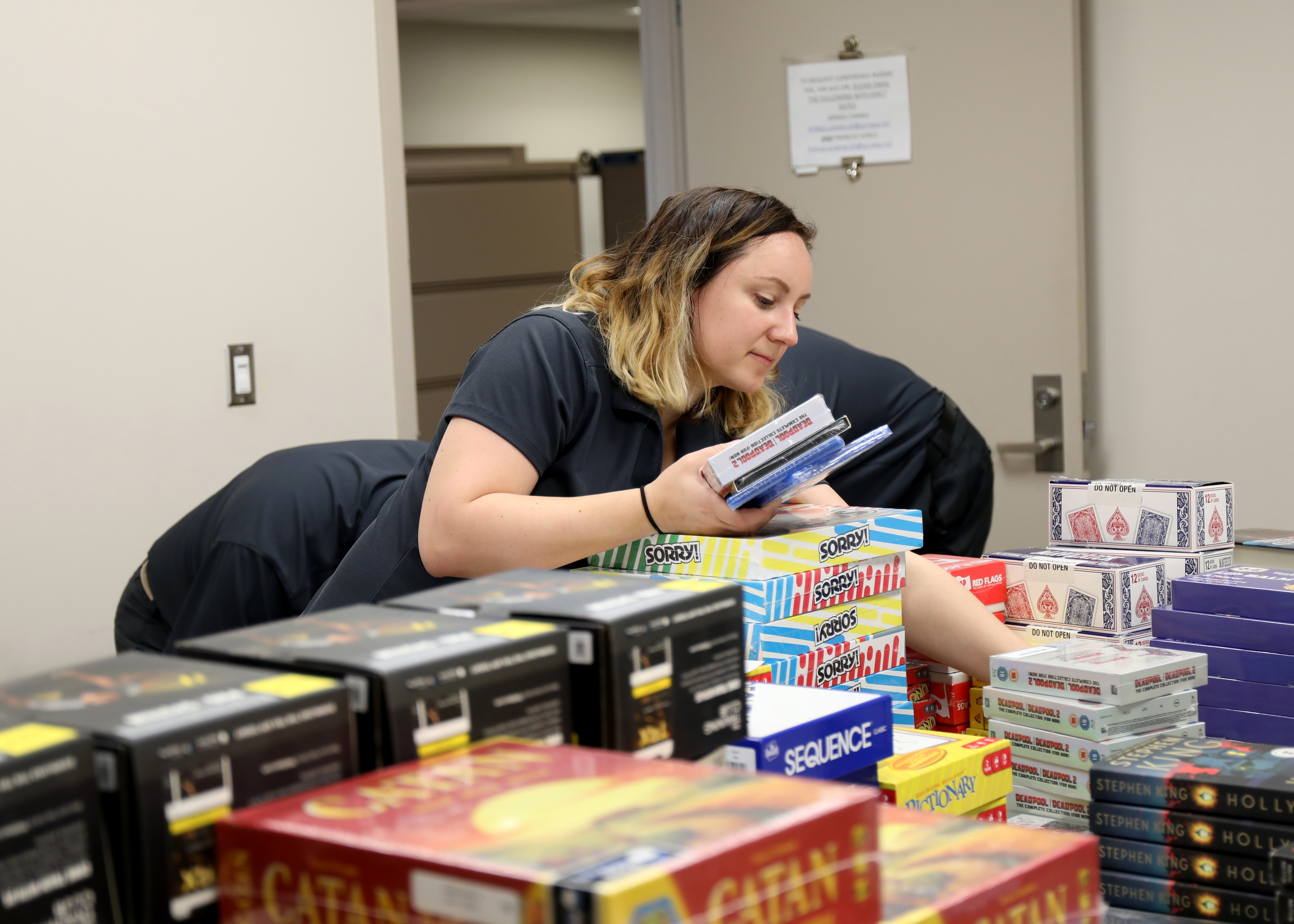 Stephanie Rusnak, Military Sealift Command Resiliency Team/Health Promotion Coordinator, builds a crew care package to be delivered to a deployed or soon to be deployed MSC ship, on Naval Station Norfolk, Jan. 10. The effort is designed foster resilience for the Civil Service Mariners who crew MSC's fleet of ships.