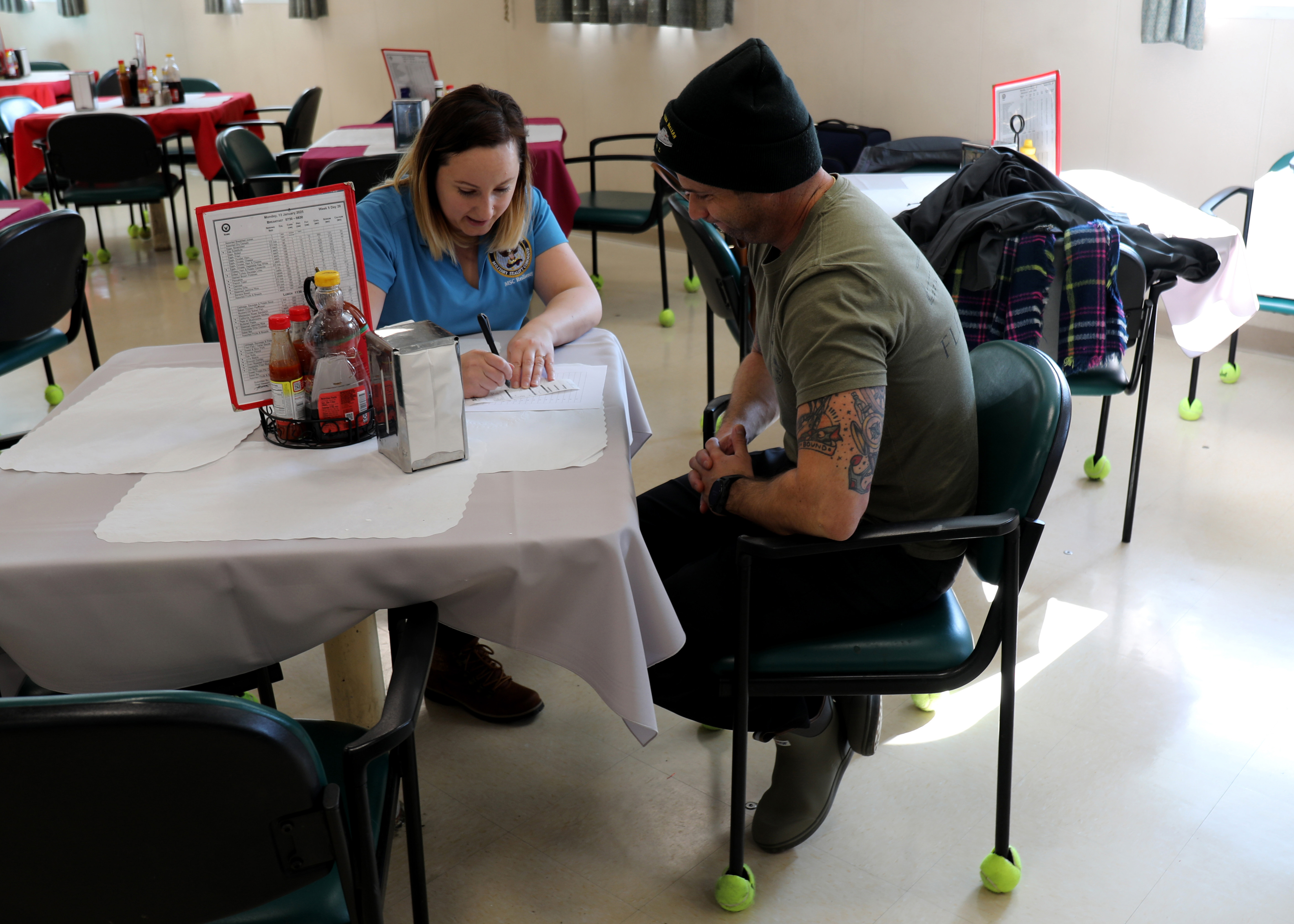 Capt. Adam Streeper, Master of Military Sealift Command's dry cargo ammunition ship USNS William McLean (T-AKE 12) receives the results from a voluntary body composition screening administered by Stephanie Rusnak, MSC Resiliency Team/Health Promotion Coordinator, while the ship was pier-side on Naval Station Norfolk, Jan. 13. The screening was part of the MSC The Resiliency/Health Promotion Team's visit to the ship to assist with building and maintaining crew resiliency aboard the ship.