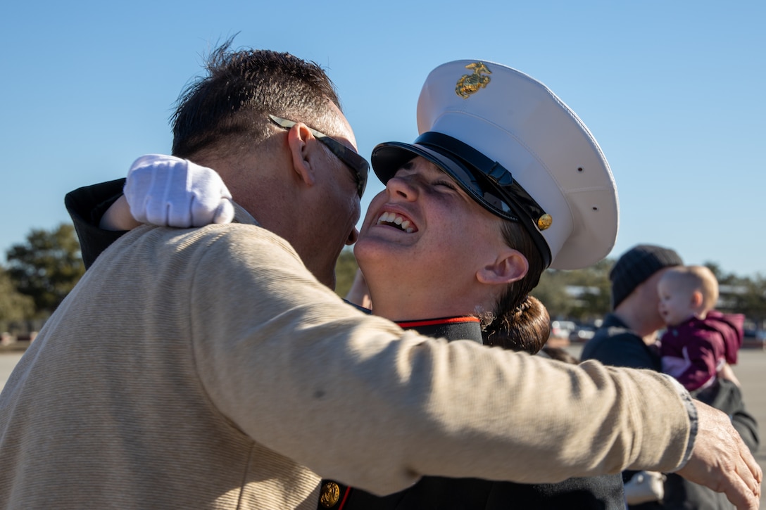 U.S. Marine Corps Gunnery Sgt. Eric Green, retired, congratulates Pfc. Hailey E. Green after completing Marine Corps Recruit Training at Marine Corps Recruit Depot Parris Island, South Carolina, Jan. 17, 2025. Green, a native of Ocean Springs, Mississippi, earned the title of November Company Honor Graduate by outperforming other recruits in her company during a series of training events design to test their basic Marine Corps skills. (U.S. Marine Corps photo by Lance Cpl. Kevin J. López Herrera)