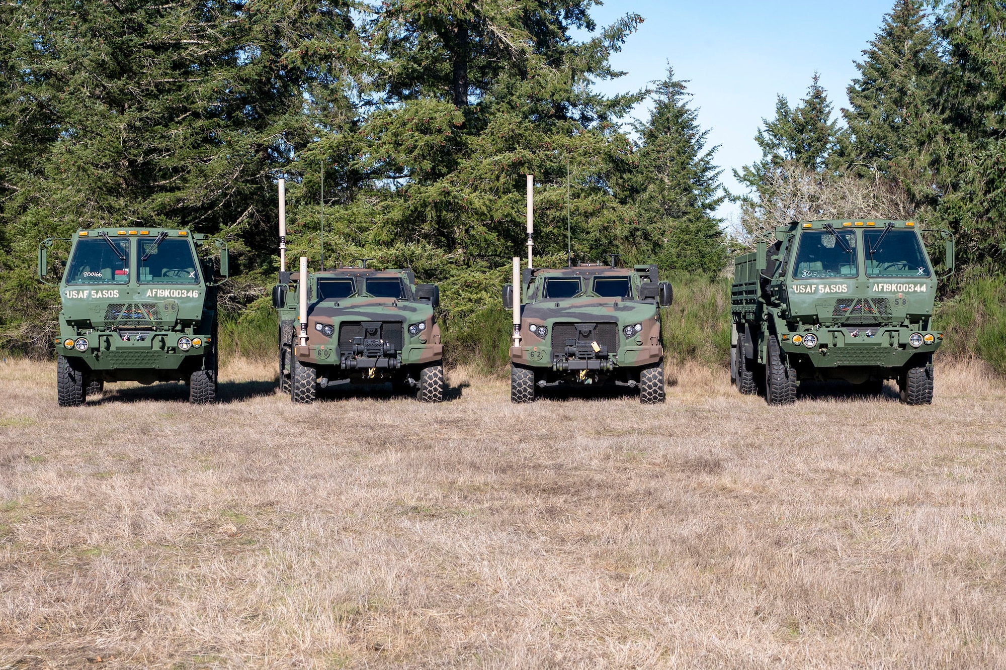 A lineup of military vehicles are staged during a field training exercise conducted by 5th Air Support Operations Squadron at Joint Base Lewis-McChord, Washington, Jan. 22, 2025.