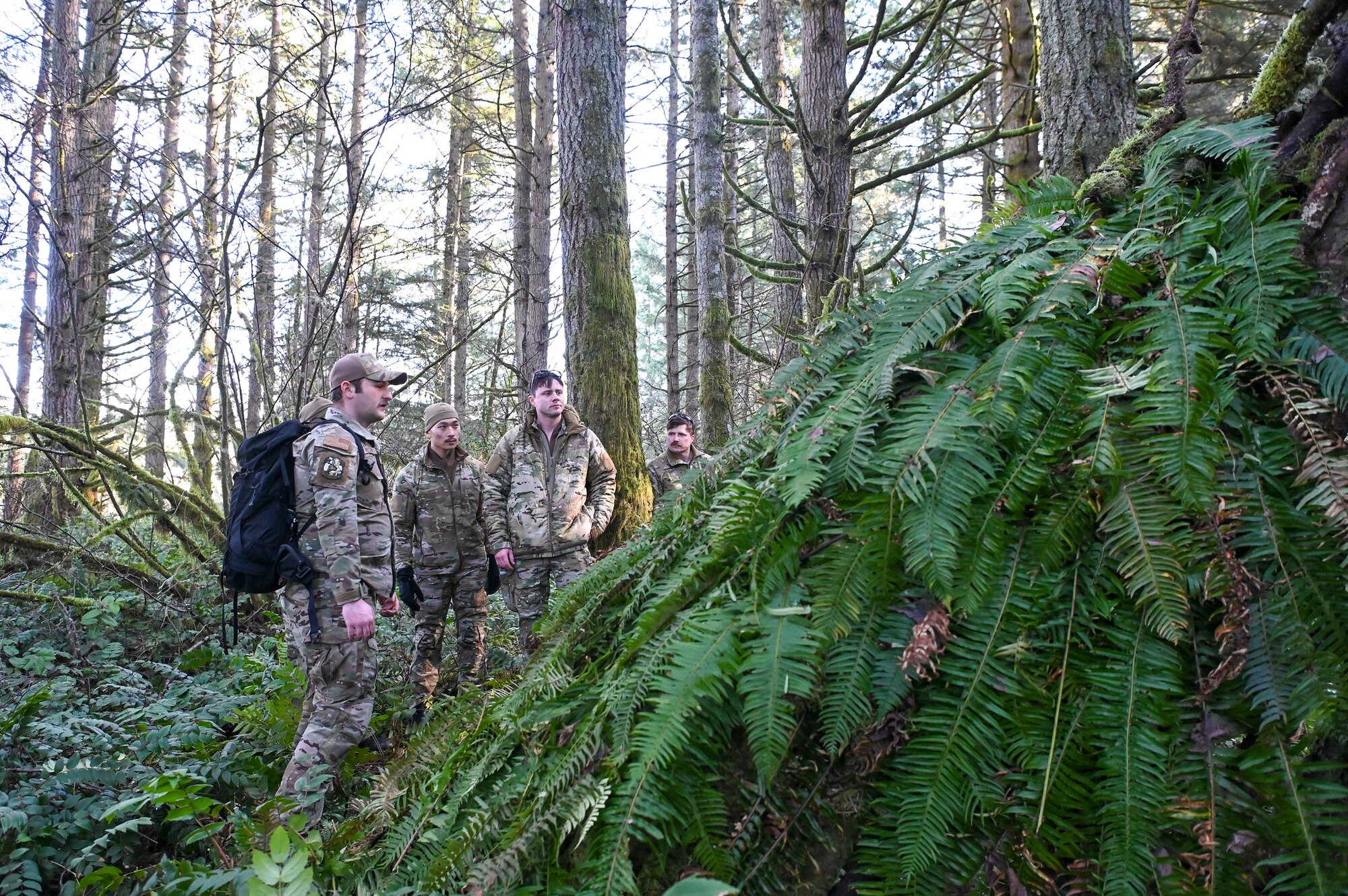 U.S. Air Force Senior Airman Patrick McGrory, 5th Air Support Operations Squadron Survival Evasion Resistance Escape specialist, instructs Airmen to construct shelters during a field training exercise at Joint Base Lewis-McChord, Washington, Jan. 22, 2025.