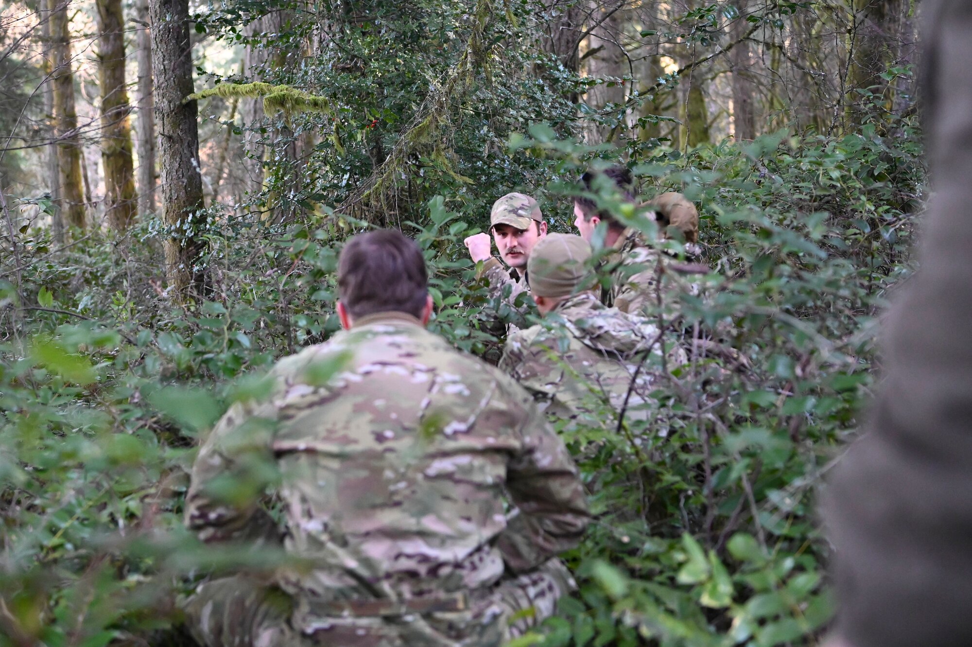U.S. Air Force Senior Airman Patrick McGrory, 5th Air Support Operations Squadron Survival Evasion Resistance Escape specialist, demonstrates evasion travel techniques to 5th ASOS Airmen during a field training exercise at Joint Base Lewis-McChord, Washington, Jan. 22, 2025.