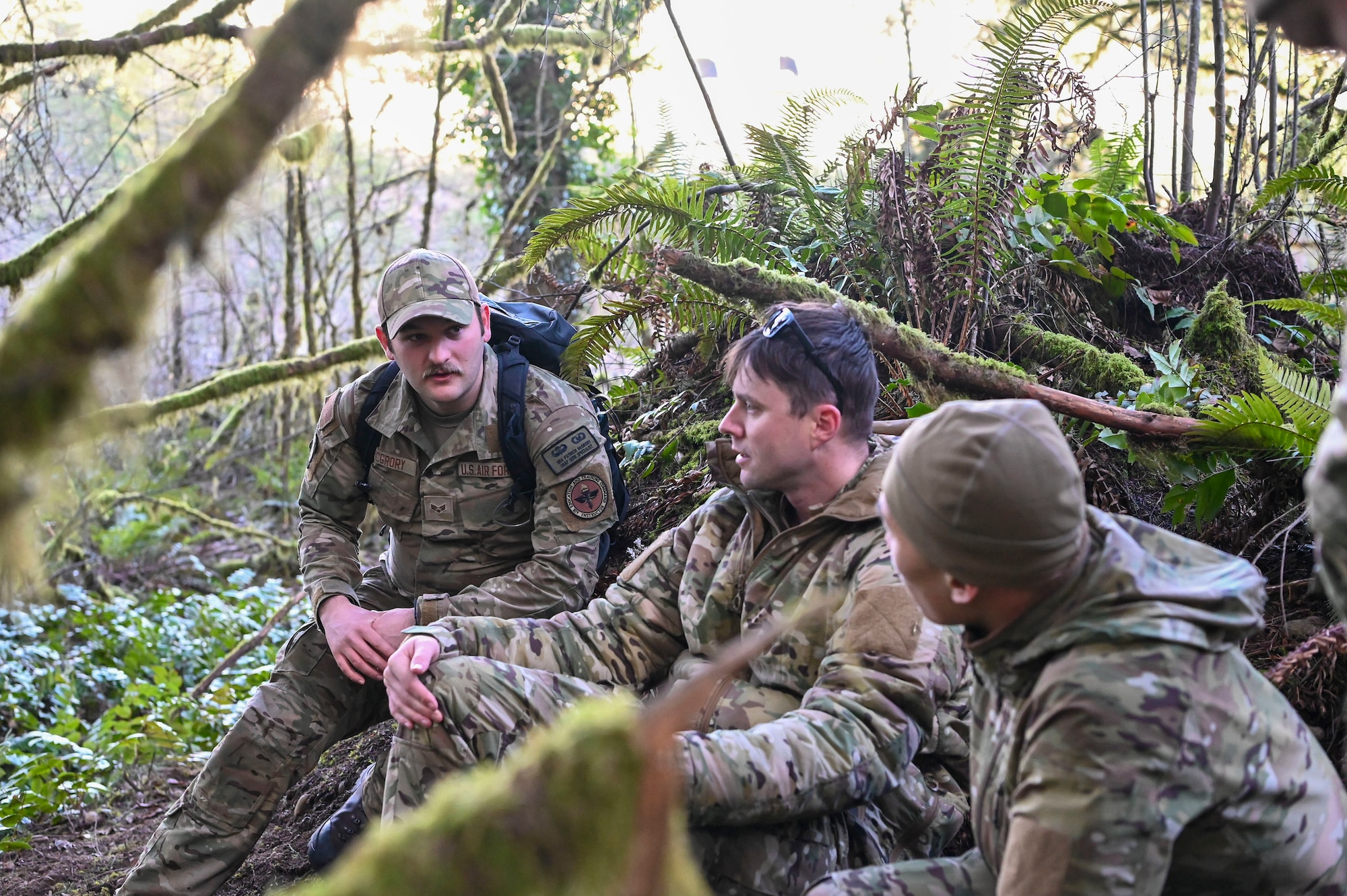 U.S. Air Force Senior Airman Patrick McGrory, 5th Air Support Operations Squadron Survival Evasion Resistance Escape specialist, relays evasion travel techniques to 5th ASOS Airmen during a field training exercise at Joint Base Lewis-McChord, Washington, Jan. 22, 2025.