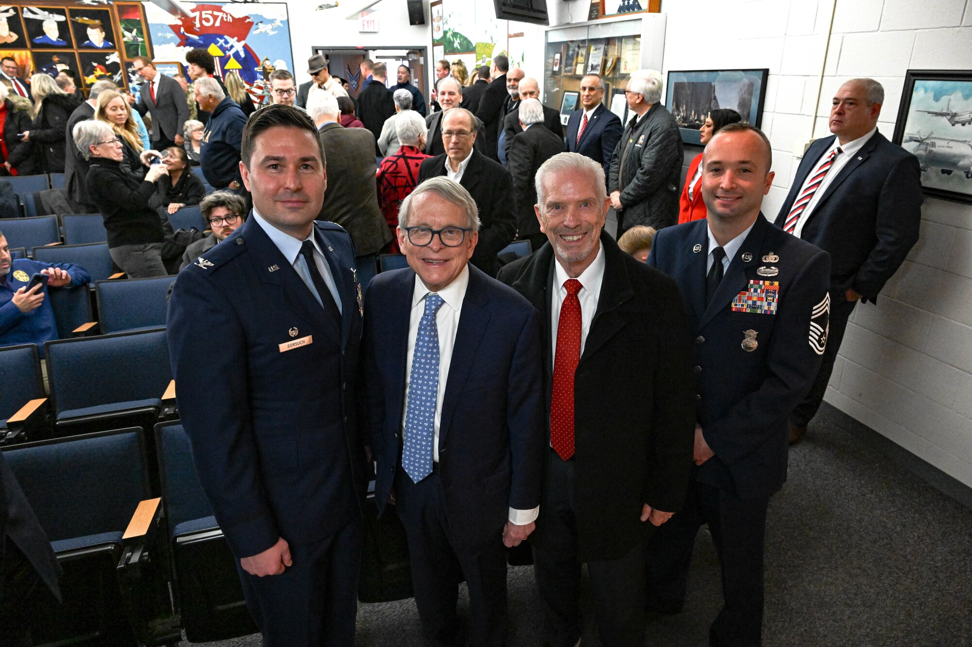 Senior leaders from the 910th Airlift Wing, Mike DeWine, Ohio Governor, and Bill Johnson, Youngstown State University president, pose for a photo on Feb. 3, 2025, at Youngstown Air Reserve Station, Ohio.