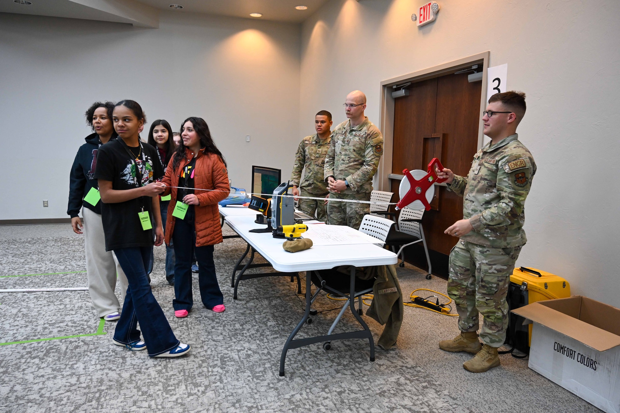 U.S. Airmen from the 97th Civil Engineer Squadron demonstrate old techniques used to measure distances to students during a Science, Technology, Engineering, Arts, and Math fair at Southwest Technology Center at Altus, Oklahoma, Jan. 22, 2025. The hands-on demonstration provided students with a glimpse into traditional engineering methods while highlighting their relevance in modern applications. (U.S. Air Force photo by Airman 1st Class Lauren Torres)