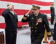 (right) Capt. David Back, outgoing Naval Surface Warfare Center Panama City Division commanding officer, salutes and exits at the conclusion of NSWC PCD's change of command ceremony held onboard Naval Support Activity Panama City, Fla., Jan. 31. Back assumed command of NSWC PCD on May 8, 2020, during the early days of the pandemic while the organization was only 19 months into its recovery from Hurricane Michael’s devastation. (U.S. Navy photo by Eddie Green)