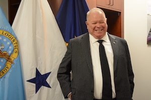 A man smiles while posing for a picture.
