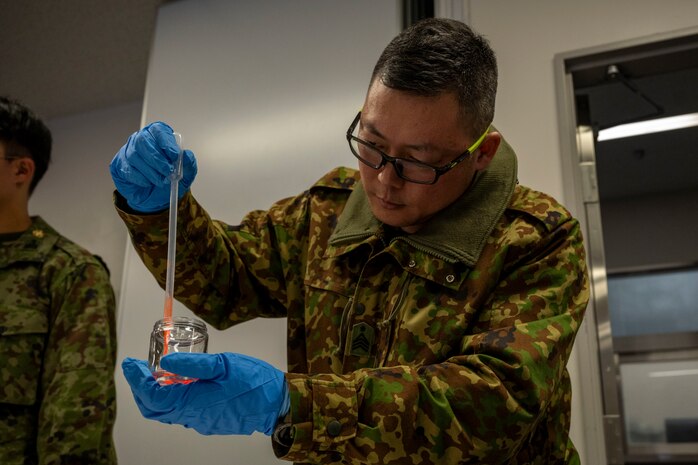 A Japan Ground Self-Defense Force (JGSDF) 9th Chemical Protection Unit soldier participates in a bilateral chemical, biological, radiological and nuclear training.