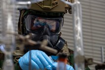 U.S. Air Force Airman Gabriel Bormann, 35th Civil Engineering Squadron emergency manager, demonstrates proper chemical, biological, radiological and nuclear (CBRN) procedure during a bilateral training.