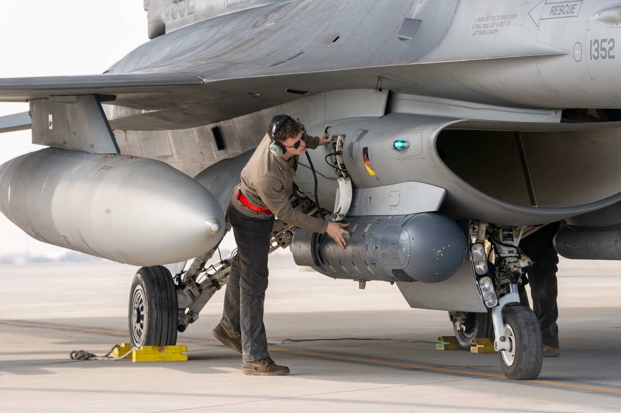 U.S. Air Force Airman 1st Class Garrett Holloway, 378th Expeditionary Aircraft Maintenance Squadron assistant dedicated crew chief, secures components within an F-16 Fighting Falcon during Exercise Spears of Victory at King Abdulaziz Air Base, Saudi Arabia, Jan. 28, 2025.
