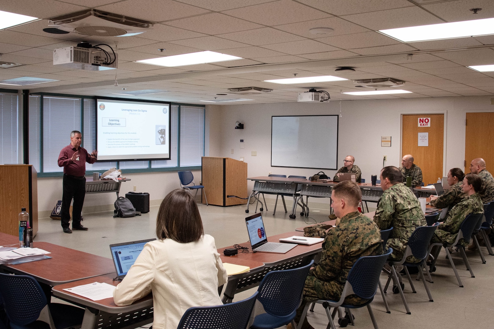 Mr. Derek Murray, PE, CSSBB, MSEM, left, introduces service members and civilians to the fundamentals of Lean Six Sigma Green Belt on January 28, 2025 aboard Naval Health Clinic Cherry Point.  Murray taught the five-day-long class to equip students with the knowledge to improve processes and reduce waste at facilities aboard Marine Corps Air Station Cherry Point.