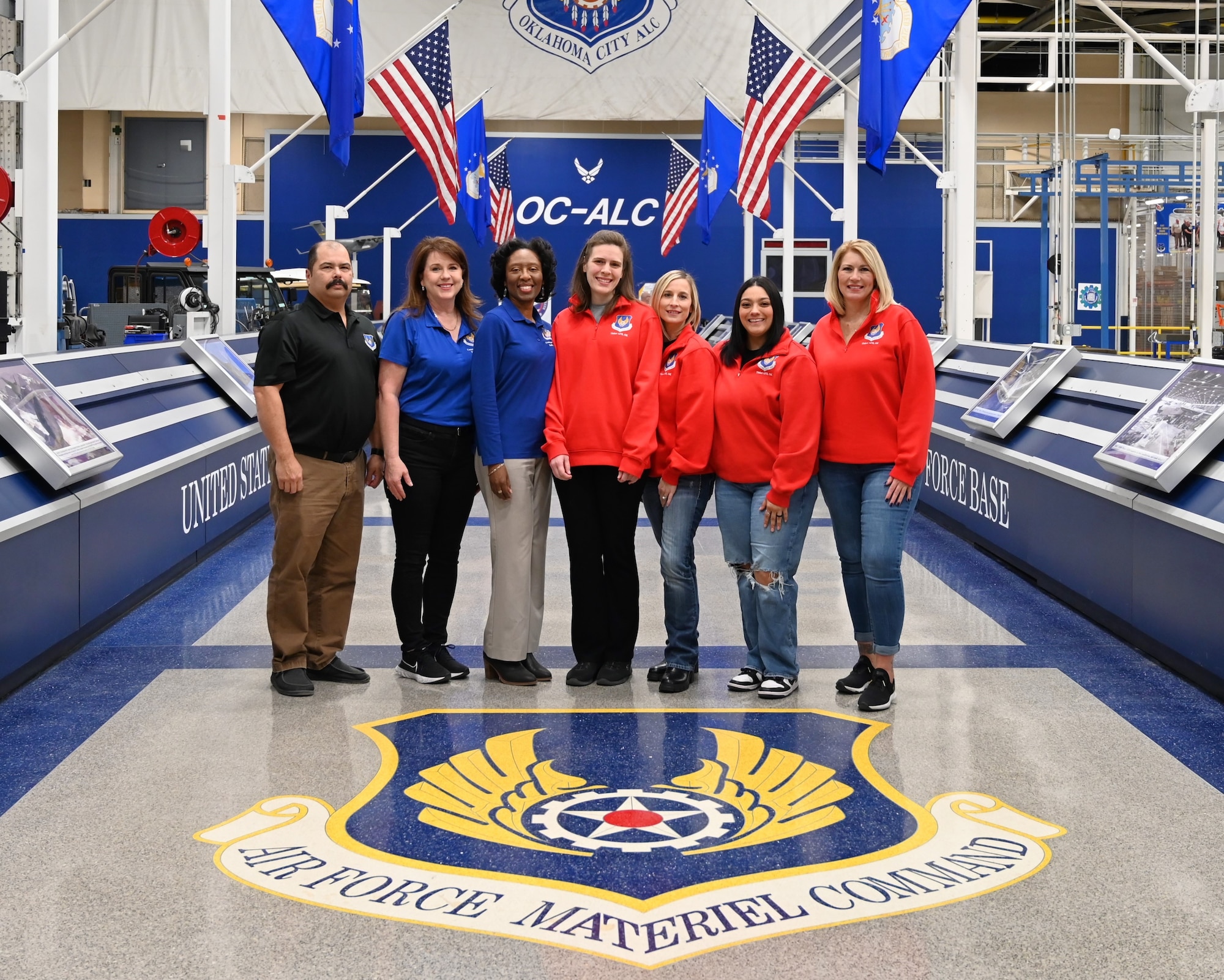 a man on the right with 6 women next to him for a photograph