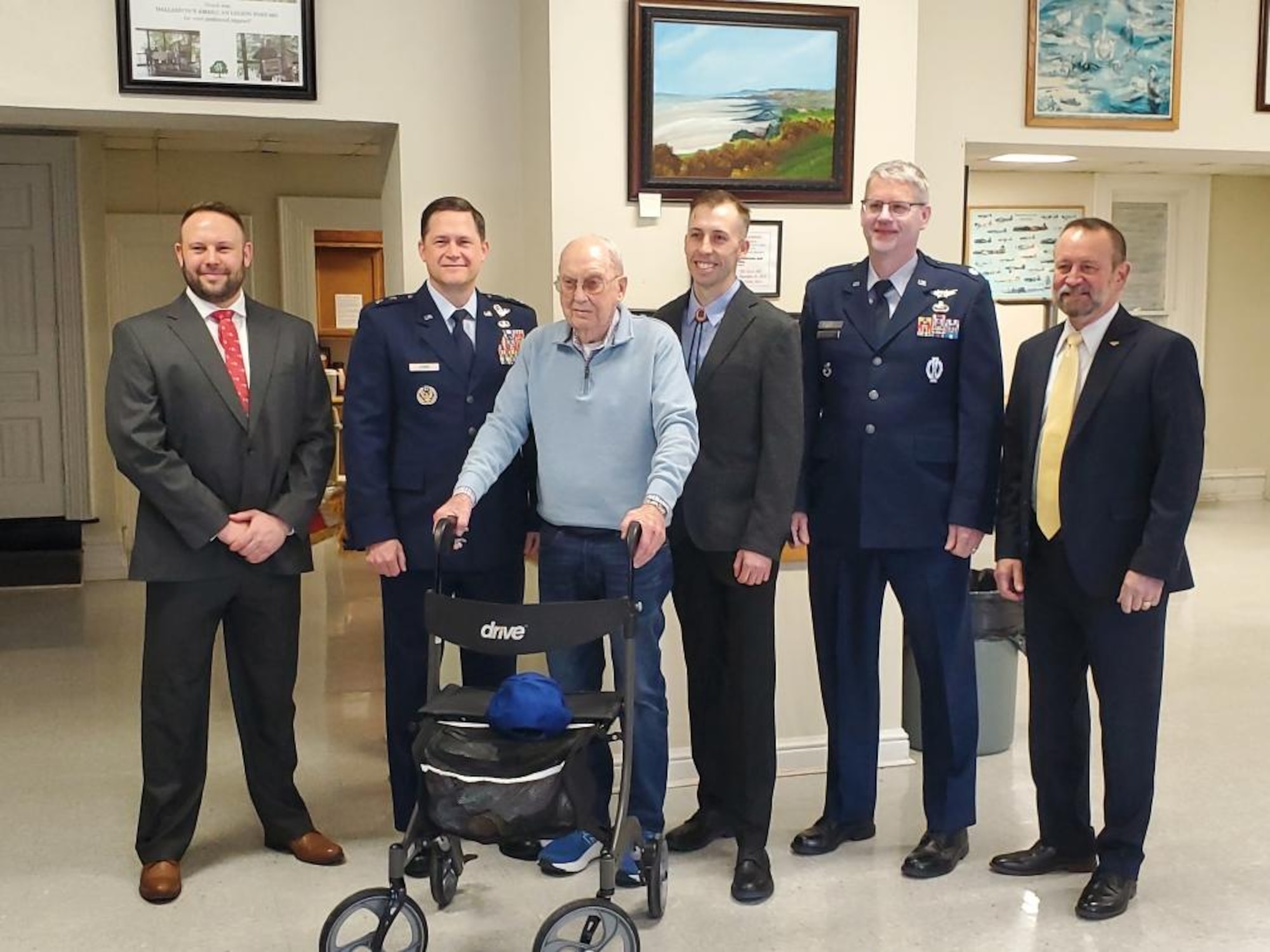 Maj. Gen. David Lyons, Fifteenth Air Force commander (second from left) poses for a picture with Sergeant Harold “Bud” Pressel (center), Eric Olson (left), Mark Olson (third from right) and members from the local American Legion on January 29, 2025, in Dallastown, PA. Lyons, presented a Purple Heart to Pressel and posthumously awarded a Purple Heart to Maj (ret.) Richard Olson for injuries sustained during World War II.