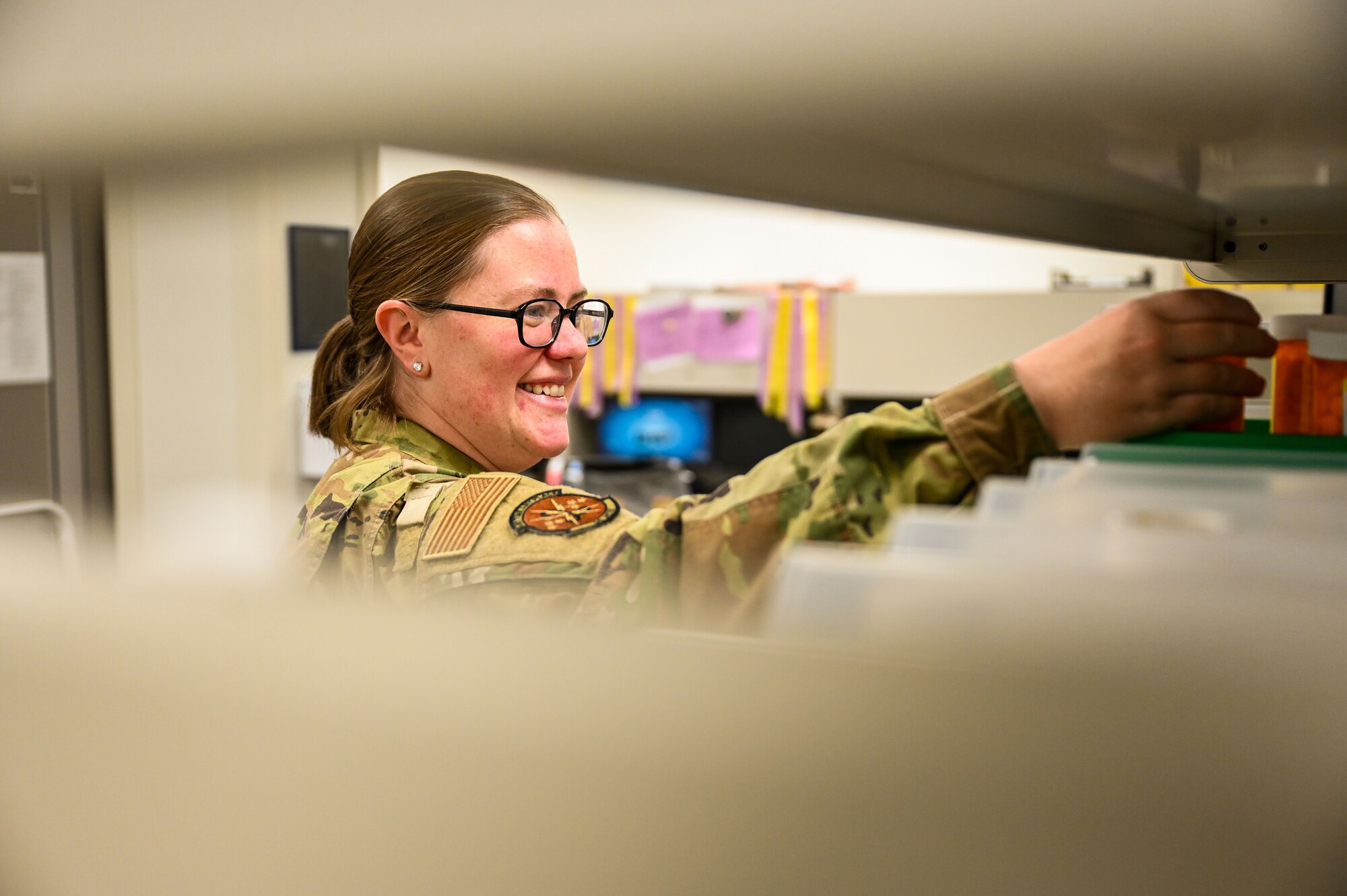Maj. Julie Carpenter, 90th Medical Group pharmacy flight commander, organizes pill bottles at F.E. Warren Air Force Base, Jan. 28, 2025. Pharmacy is one of the 13 Air Force Specialty Codes within the Biomedical Science Corps, which is responsible for ensuring the care of military members. (U.S. Air Force photo by Airman 1st Class Mattison Cole)