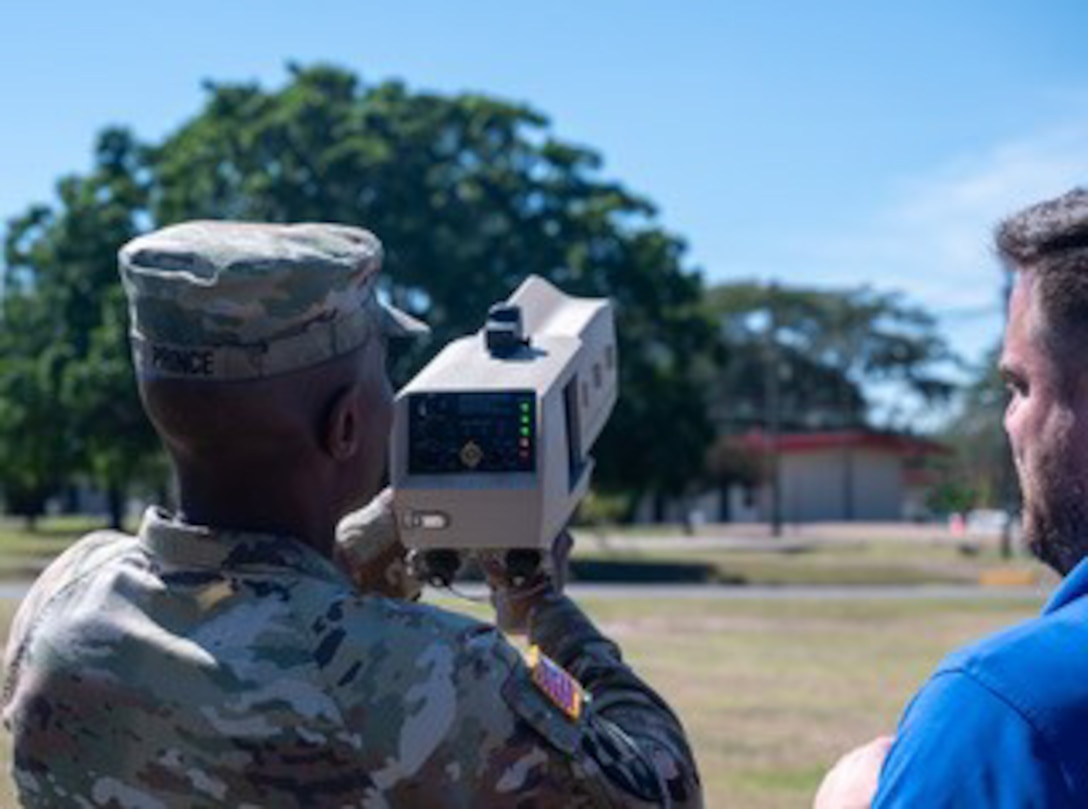 Nicholas Bennett, of the Axient IFRCO C-UAS MIST Team, helps Col. William Prince, commander of Army Support Activity at Soto Cano Air Base, January 21, 2025, operate the new Dronebuster defeat system.