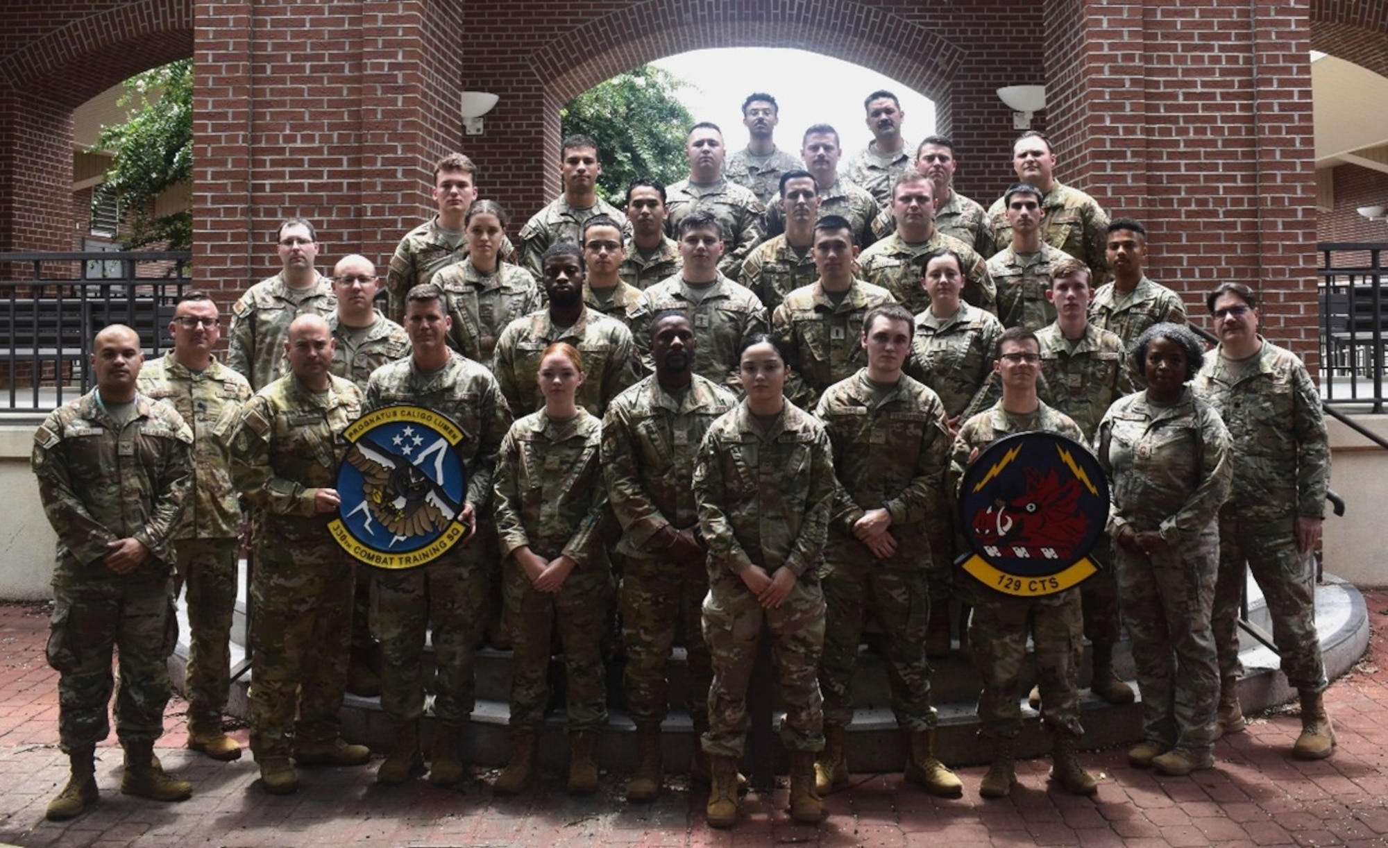 Members of the 129th and 330th Combat Training Squadrons pose for a photo