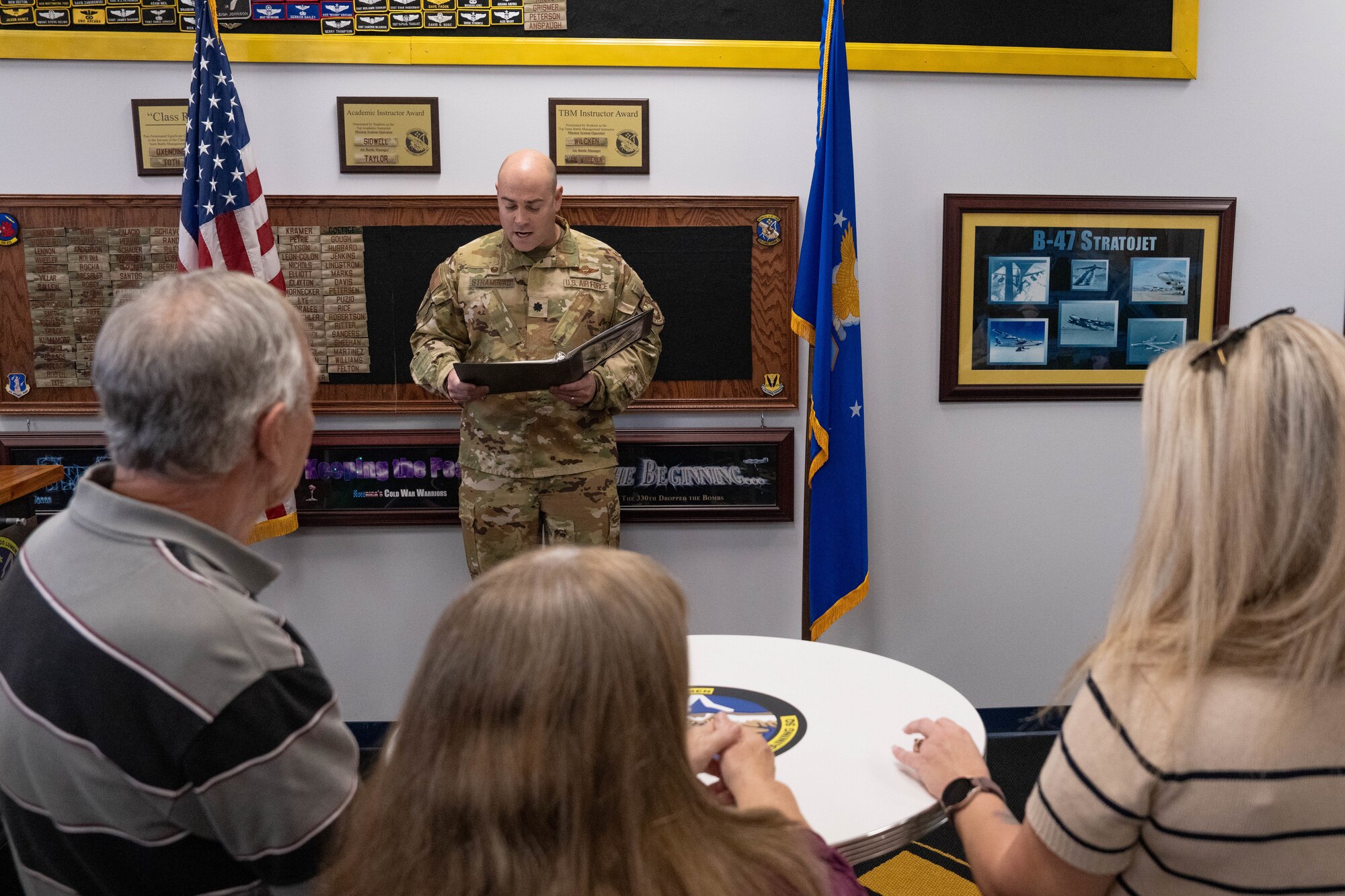 Lt. Col. Kyle Stramblad, 330th Combat Training Squadron commander, speaks to the family members of the late Master Sgt. Brian Baldwin, a former 330th CTS evaluator aviator, during a dedication ceremony