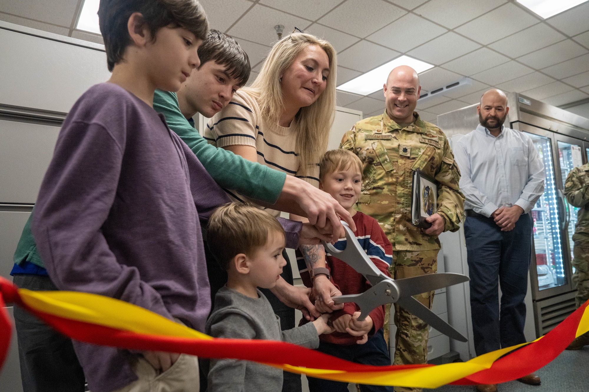 Family members of the late Master Sgt. Brian Baldwin, a former 330th Combat Training Squadron evaluator aviator, cut a ribbon to open a classroom dedicated in his honor