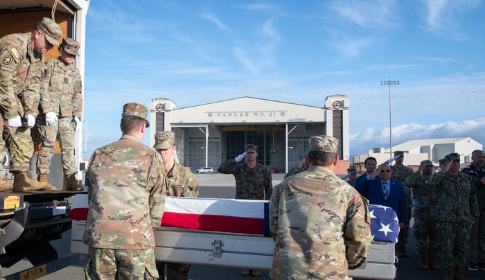 Members of the Defense POW/MIA Accounting Agency load a transfer case for transport during an honorable carry ceremony at Joint Base Pearl Harbor-Hickam, Hawaii, Jan. 28, 2025.