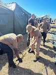 Sailors assigned to Freedom-variant littoral combat ship USS St. Louis (LCS 19) and Coast Guardsmen assigned to U.S. Coast Guard District 7 erect expeditionary shelter tents in support of the Naval Station Guantanamo Bay’s Migrant Operations Center expansion February 2, 2025. At the direction of the President of the United States to the Department of Homeland Security (DHS) and the Department of Defense, U.S. military service members are supporting removal operations led by DHS at Naval Station Guantanamo Bay.