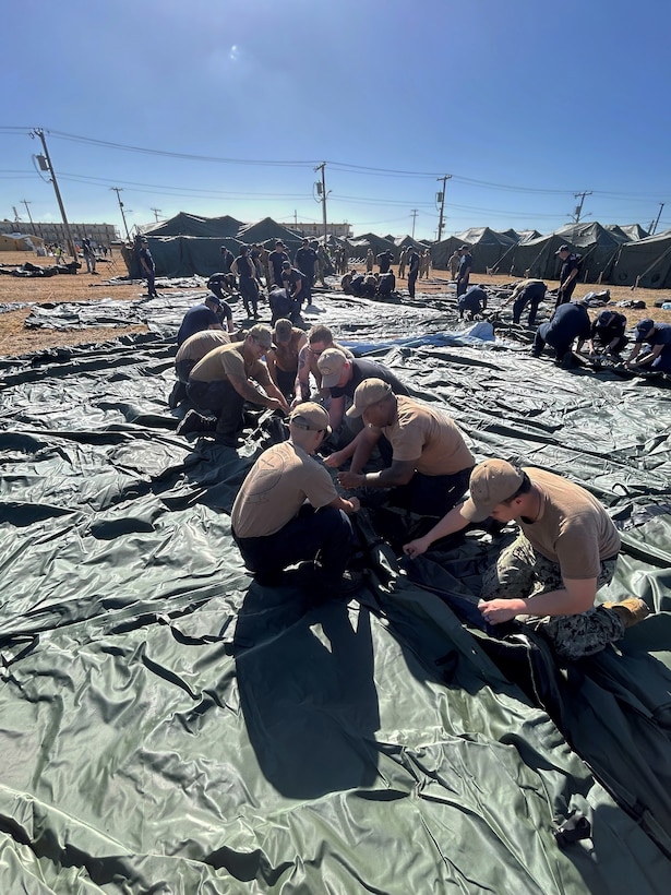 Sailors assigned to Freedom-variant littoral combat ship USS St. Louis (LCS 19) and Coast Guardsmen assigned to assigned to Coast Guard Cutter Resolute erect expeditionary shelter tents in support of the Naval Station Guantanamo Bay’s Migrant Operations Center expansion February 2, 2025, as part of Operation Southern Guard. At the direction of the President of the United States to the Department of Homeland Security (DHS) and the Department of Defense, U.S. military service members are supporting removal operations led by DHS at Naval Station Guantanamo Bay.