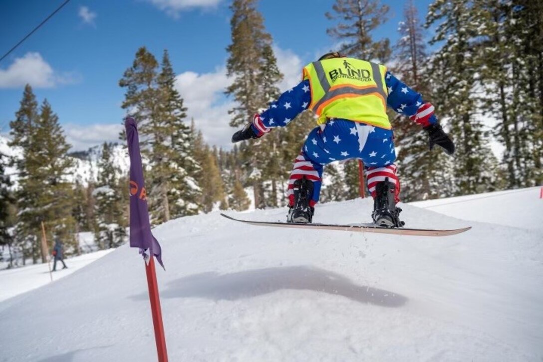 Mike Murphy is airborne while snowboarding in a competition in Vermont in March 2024