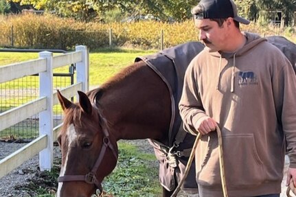 Spc. Kaden Cobban bonds with a horse during equine therapy.