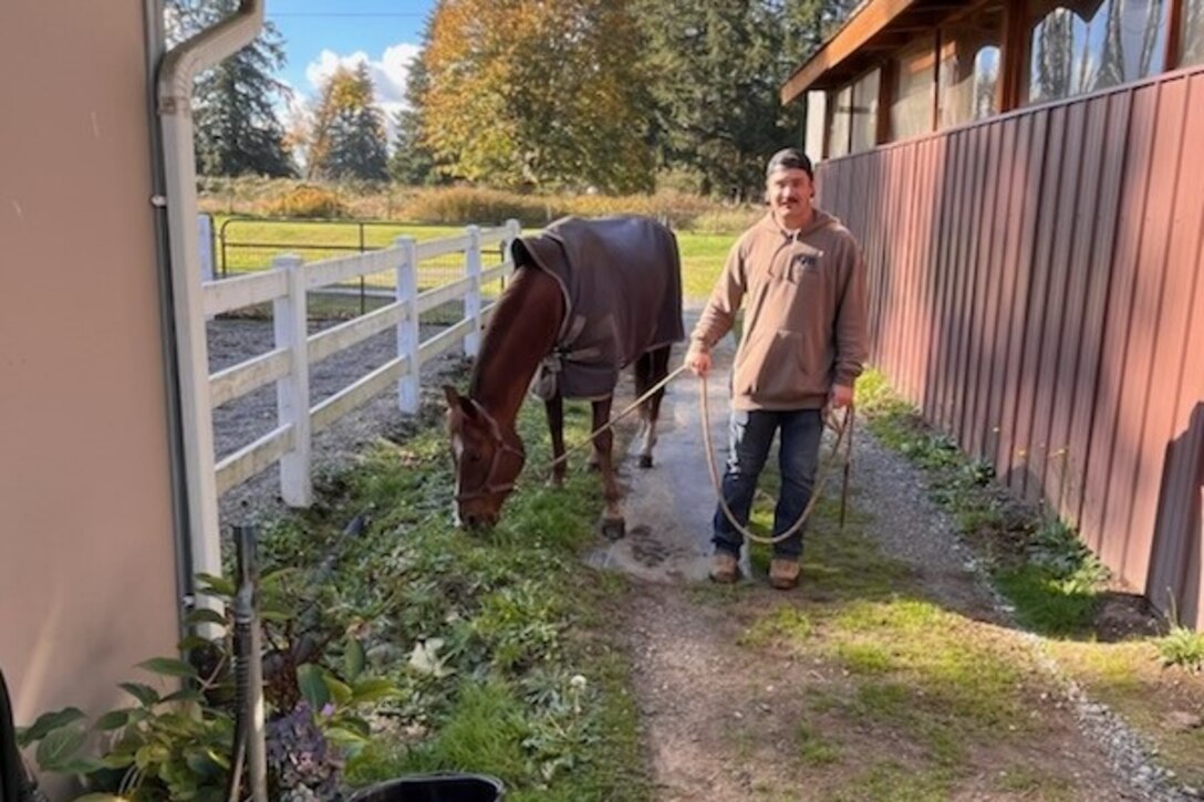 Spc. Kaden Cobban bonds with a horse during equine therapy.