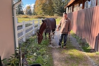 Spc. Kaden Cobban bonds with a horse during equine therapy.