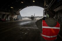 Airman marshals an F-16