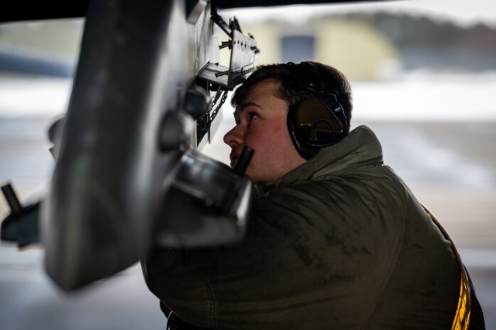 Airman inspects a wing weapons pylon