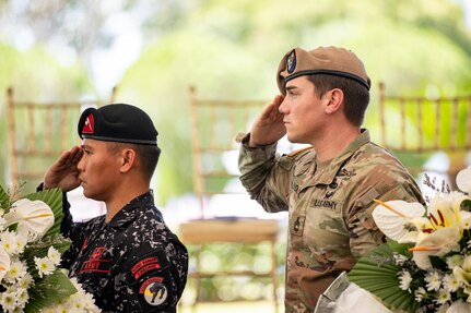 A Philippine Army Soldier from the First Scout Ranger Regiment and a U.S. Army Ranger assigned to 2nd Battalion, 75th Ranger Regiment, salutes the colors during the commemoration of the 80th Anniversary of the Raid and Liberation of Cabanatuan Prisoner of War Camp at the City of Cabanatuan, Philippines, Feb. 1, 2025.