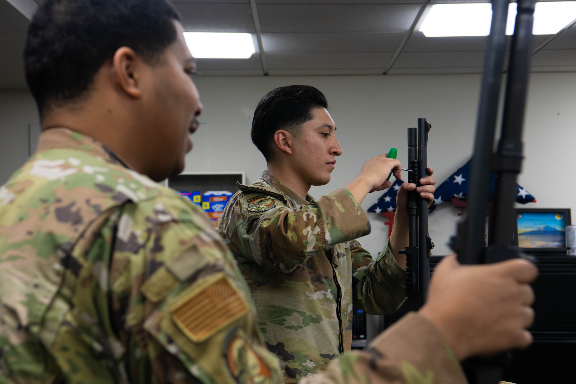 From the left, U.S. Air Force Senior Airman Keshawn Carmen, 374th Security Forces Squadron base defense leader, and Senior Airman Eduardo Ortiz, 374th SFS counter small unmanned aircraft systems trainer, participate in the classroom portion of the Defender’s Qualification Course.