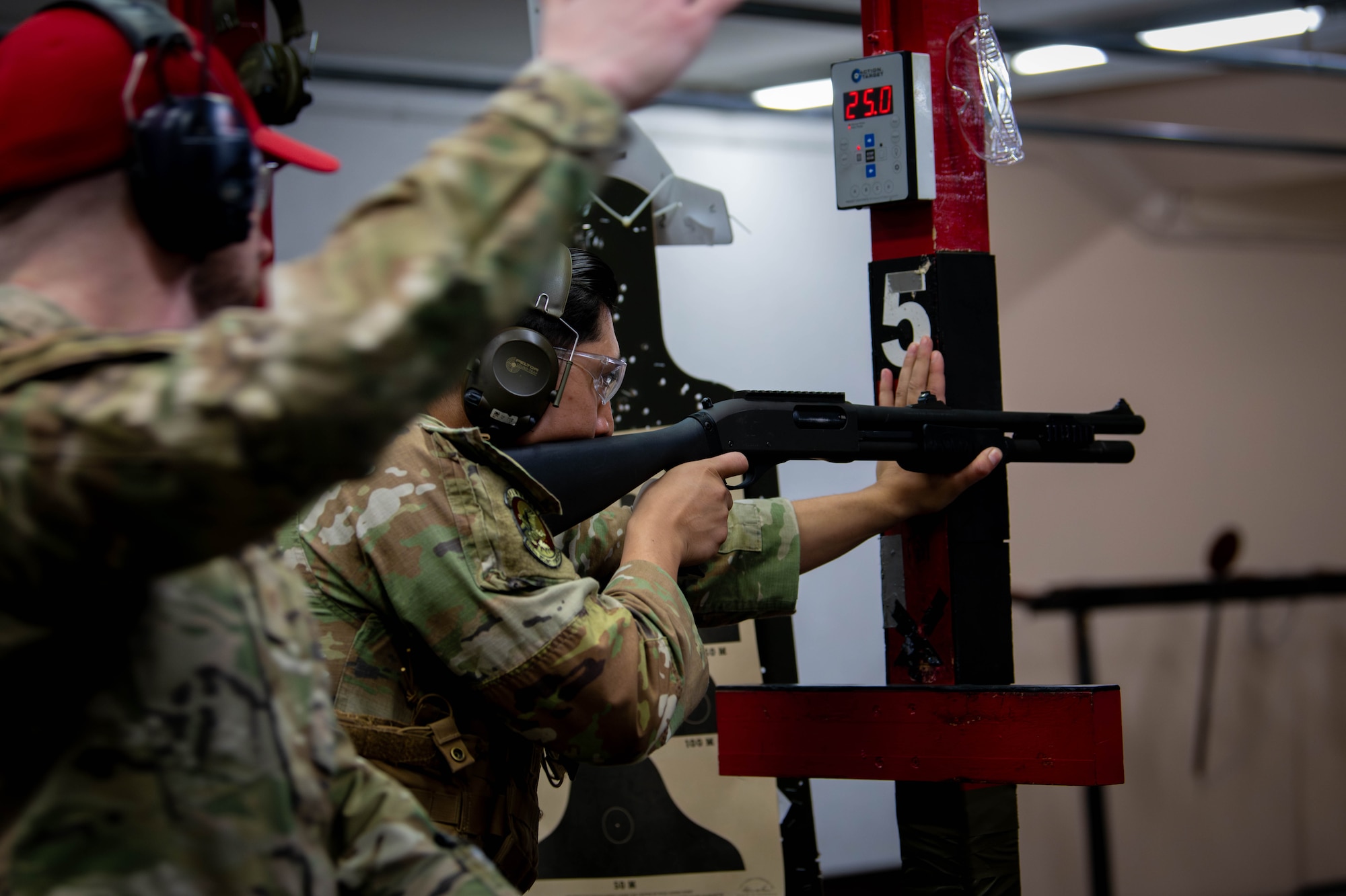 U.S. Air Force Staff Sgt. Tyler Rouillard, 374th Security Forces Squadron combat arms training and maintenance instructor, signals for Senior Airman Eduardo Ortiz, 374th SFS counter small unmanned aircraft systems trainer, to begin firing a M870 shotgun.