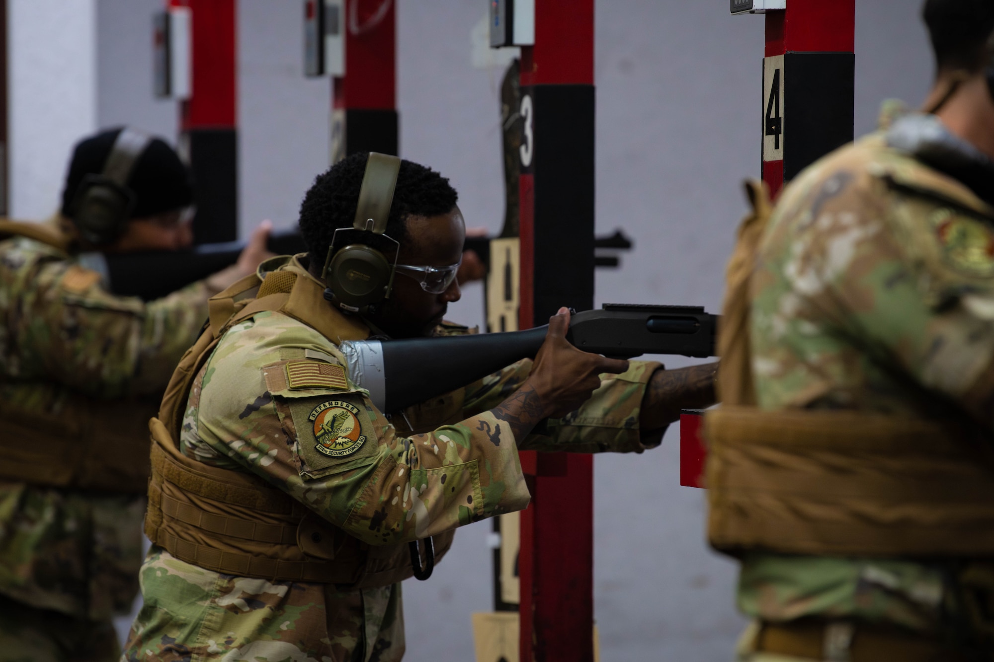 U.S. Air Force defenders assigned to the 374th Security Forces Squadron fire M870 shotguns.