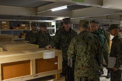 U.S. Marine Corps Brig. Gen. Kevin Collins, commanding general of 3rd Marine Logistics Group, center, and members of his command staff tour an ammunition supply warehouse with members of the Western Army Logistics Support Unit at the Kyushu District Depot on Camp Metabaru, Japan, Jan. 27, 2025.