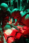 Lt. Erick Brickson and Hospital Corpsman 1st Class Christopher Grotzer secure a pelvic binder onto a high-fidelity manikin patient on board a V-22 Osprey simulator during a training exercise as part of the integrated Expeditionary Resuscitative Surgical System (ERSS) and En-route Care System (ERCS) training conducted by the Naval Expeditionary Medicine Warfighter Development Center (NEMWDC) at Bravo 1 Range, Camp Pendleton, Jan. 20. Brickson, a flight nurse with the Navy Reserve En-Route Care System based at Camp Pendleton, and Grotzer, a paramedic in his civilian career and a corpsman with the Navy Reserve En-Route Care System, also based at Camp Pendleton, participated in the training. (U.S. Navy photo by Petty Officer 2nd Class Moira Esquivel)