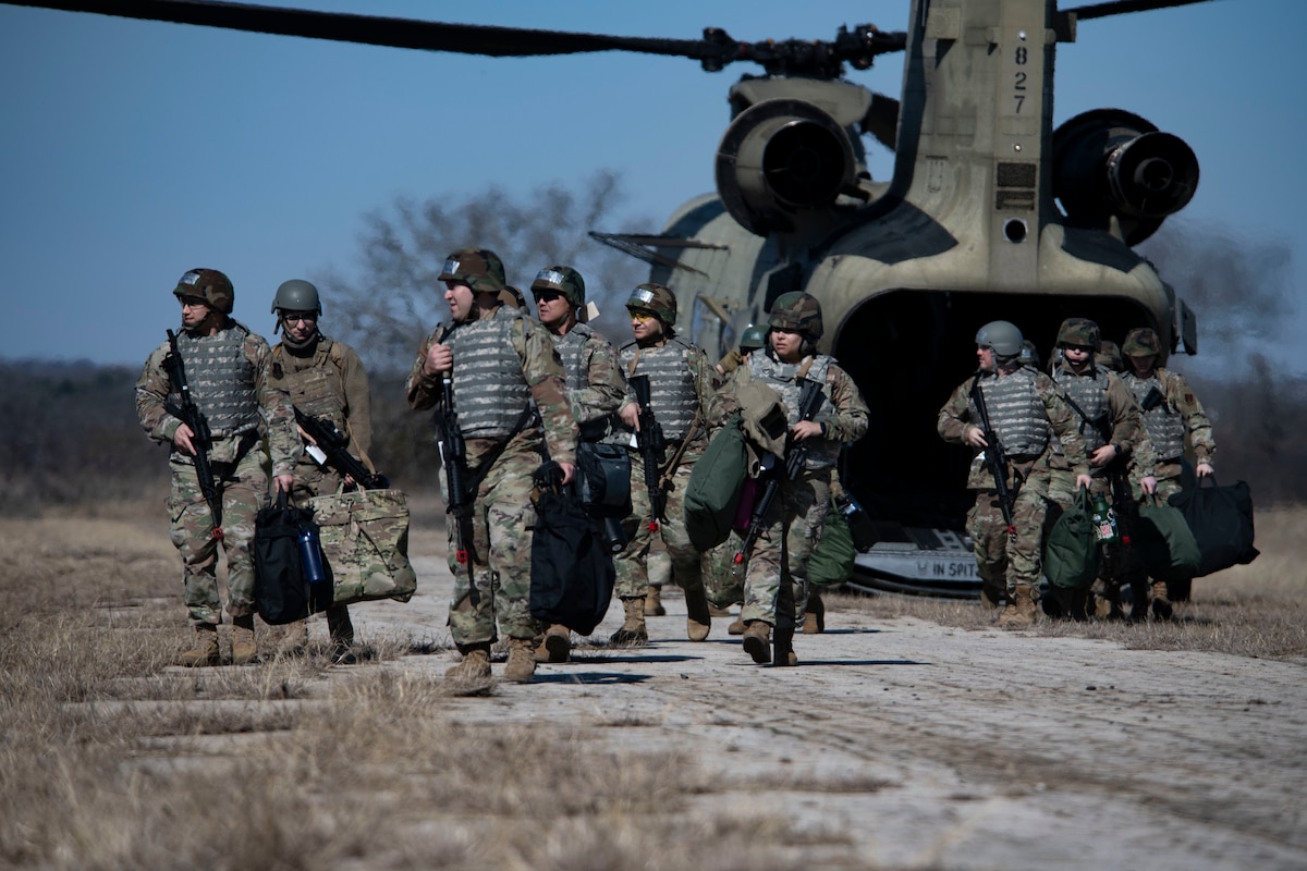 Members of the 221st Combat Communications Squadron depart a Texas Army National Guard CH-47F Chinook belonging to the 149th Aviation Battalion during Exercise FrostByte ACE at Fort Wolters Training Site, Mineral Wells, Texas, Jan. 30, 2025. The nine-day exercise enabled Airmen to train on setting up forward positions in austere locations.