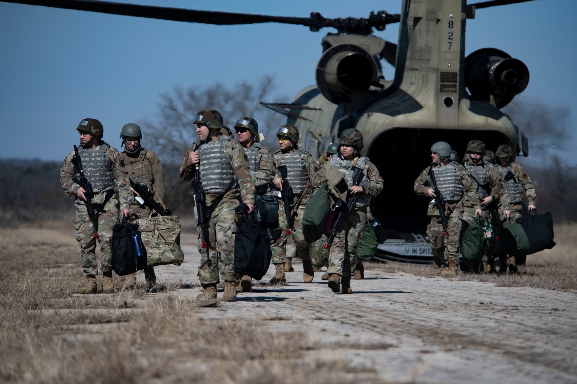 Members of the 221st Combat Communications Squadron depart a Texas Army National Guard CH-47F Chinook belonging to the 149th Aviation Battalion during Exercise FrostByte ACE at Fort Wolters Training Site, Mineral Wells, Texas, Jan. 30, 2025. The nine-day exercise enabled Airmen to train on setting up forward positions in austere locations.